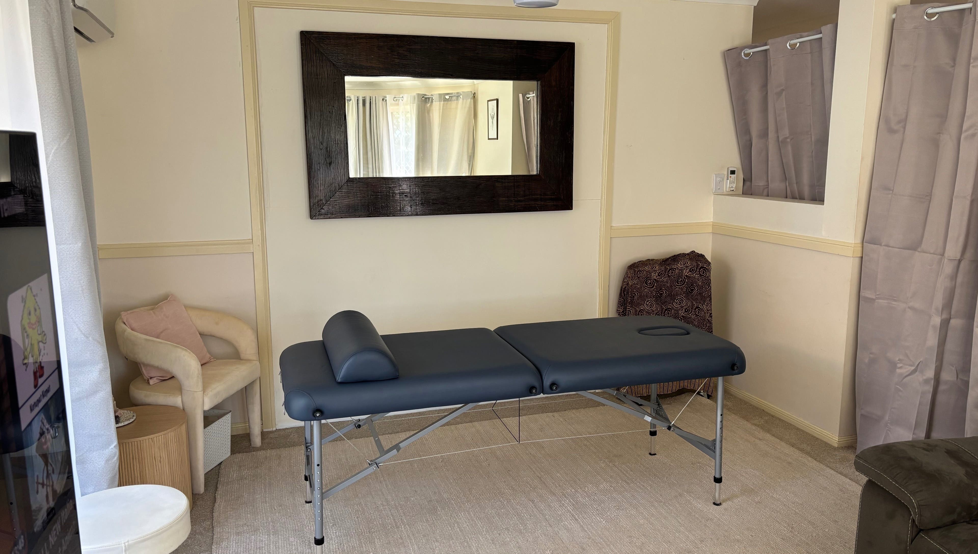 Relaxing treatment room at Muscle Recovery, Murrumba Downs, Queensland, AU with massage table and seating.