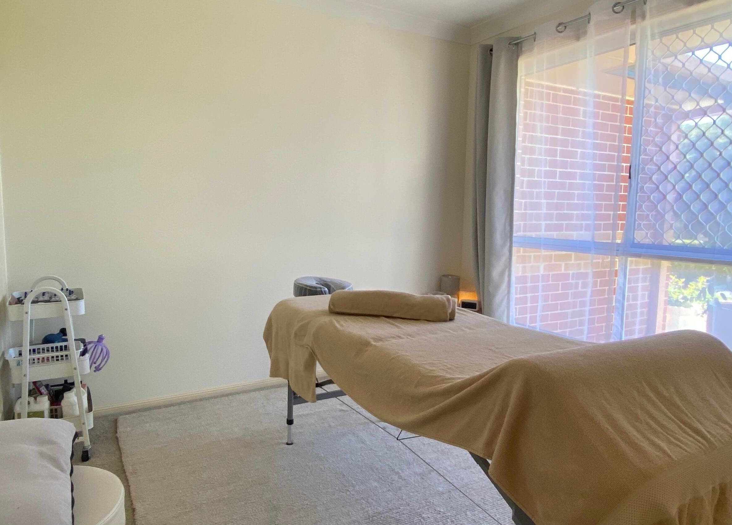Massage room at Muscle Recovery, Murrumba Downs, Queensland, AU, featuring a treatment bed in natural light.