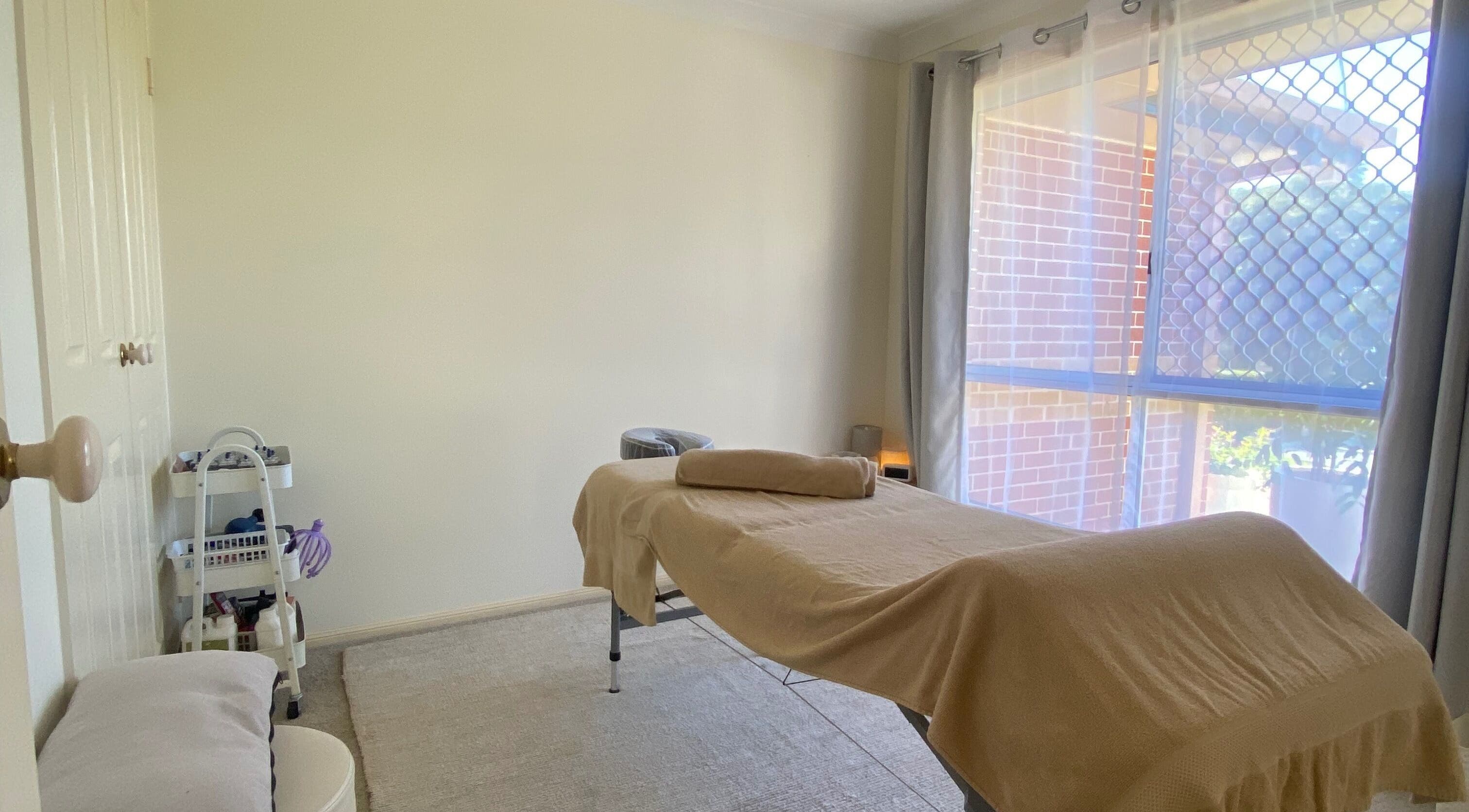 Massage room at Muscle Recovery, Murrumba Downs, Queensland, AU, featuring a treatment bed in natural light.
