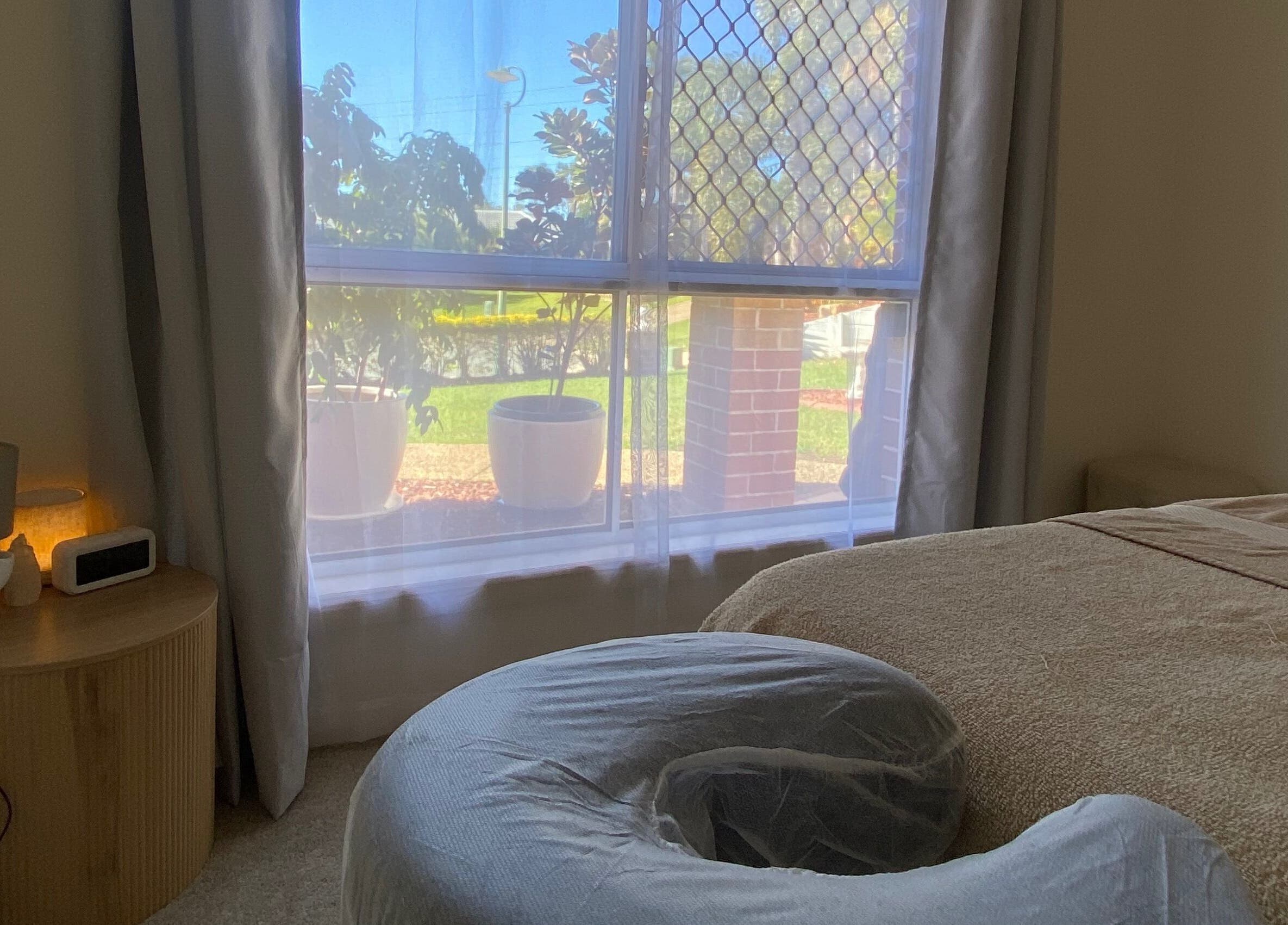 Relaxing massage room at Muscle Recovery, Murrumba Downs, Queensland, AU with tranquil natural light.