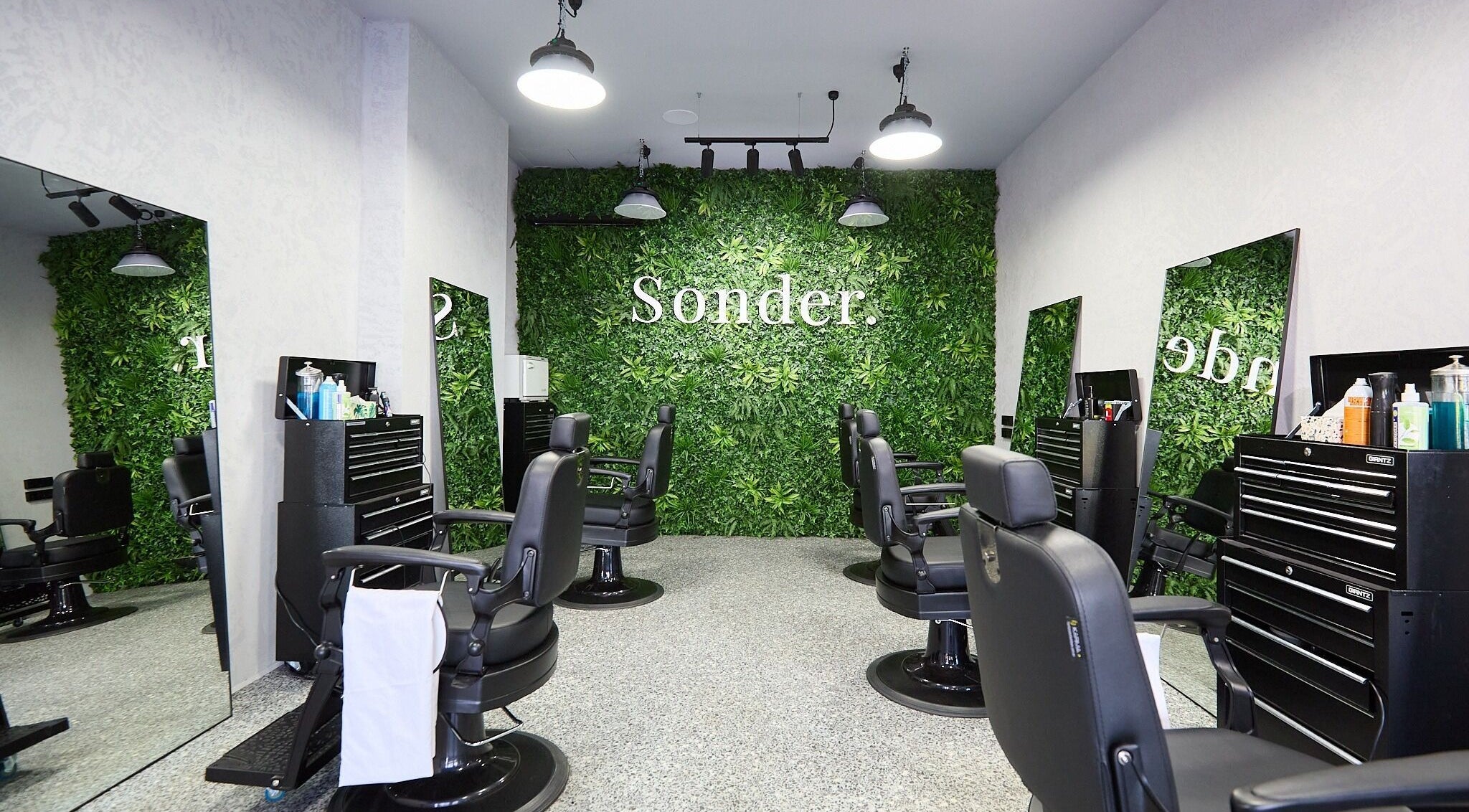 Chic interior of Sonder Mens | Bondi Junction, featuring lush greenery walls in Bondi Junction, New South Wales, AU.