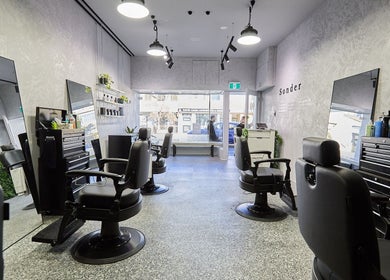 Modern salon interior at Sonder Mens | Bondi Junction, Bondi Junction, New South Wales, AU with sleek chairs.