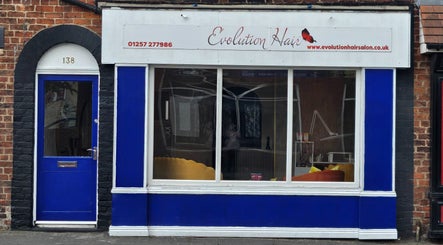 Evolution Hair salon storefront with blue accents in Chorley, England, GB.