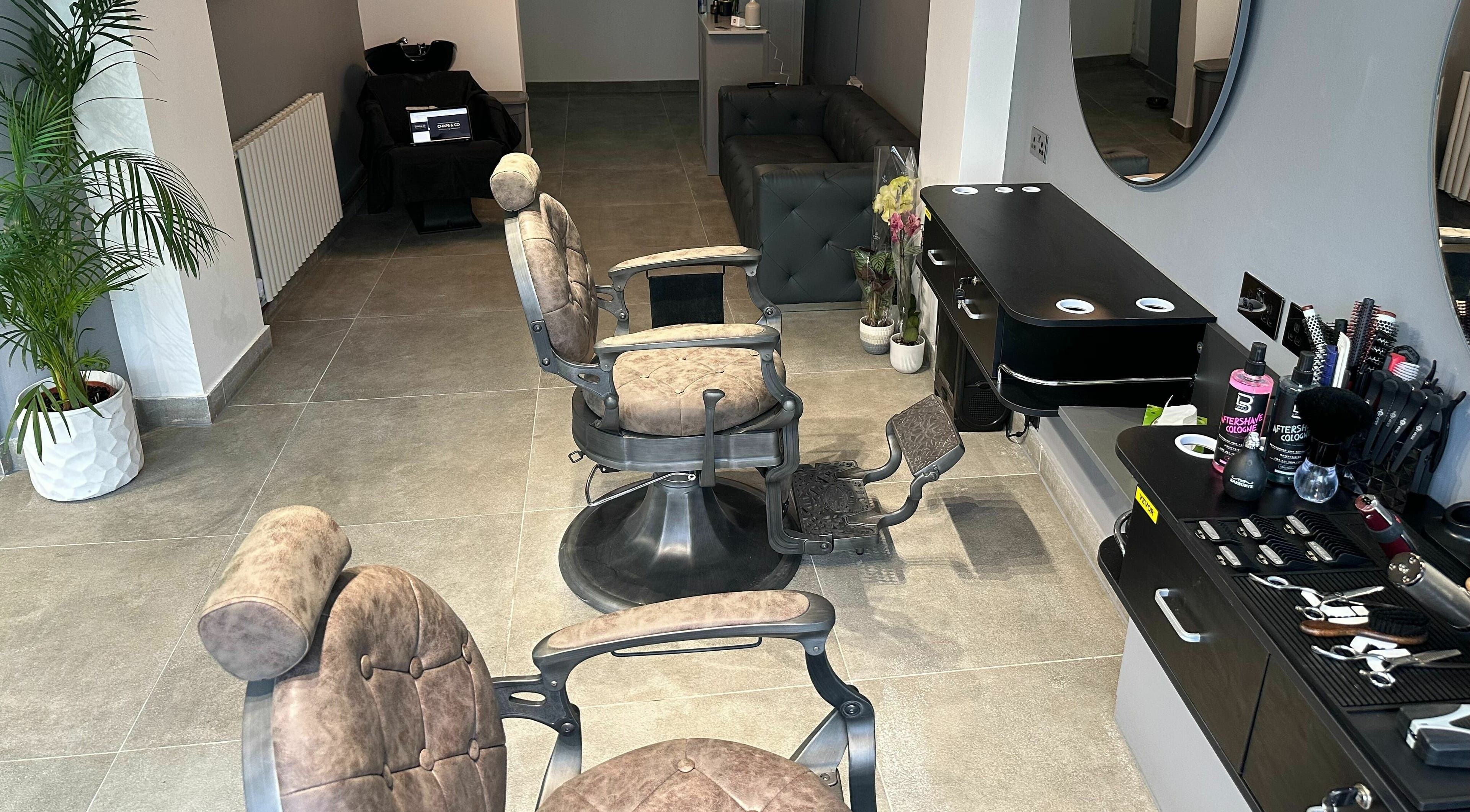 Barber chairs and styling area at Chaps Cut, Barnet, England, GB showcasing modern interior design.