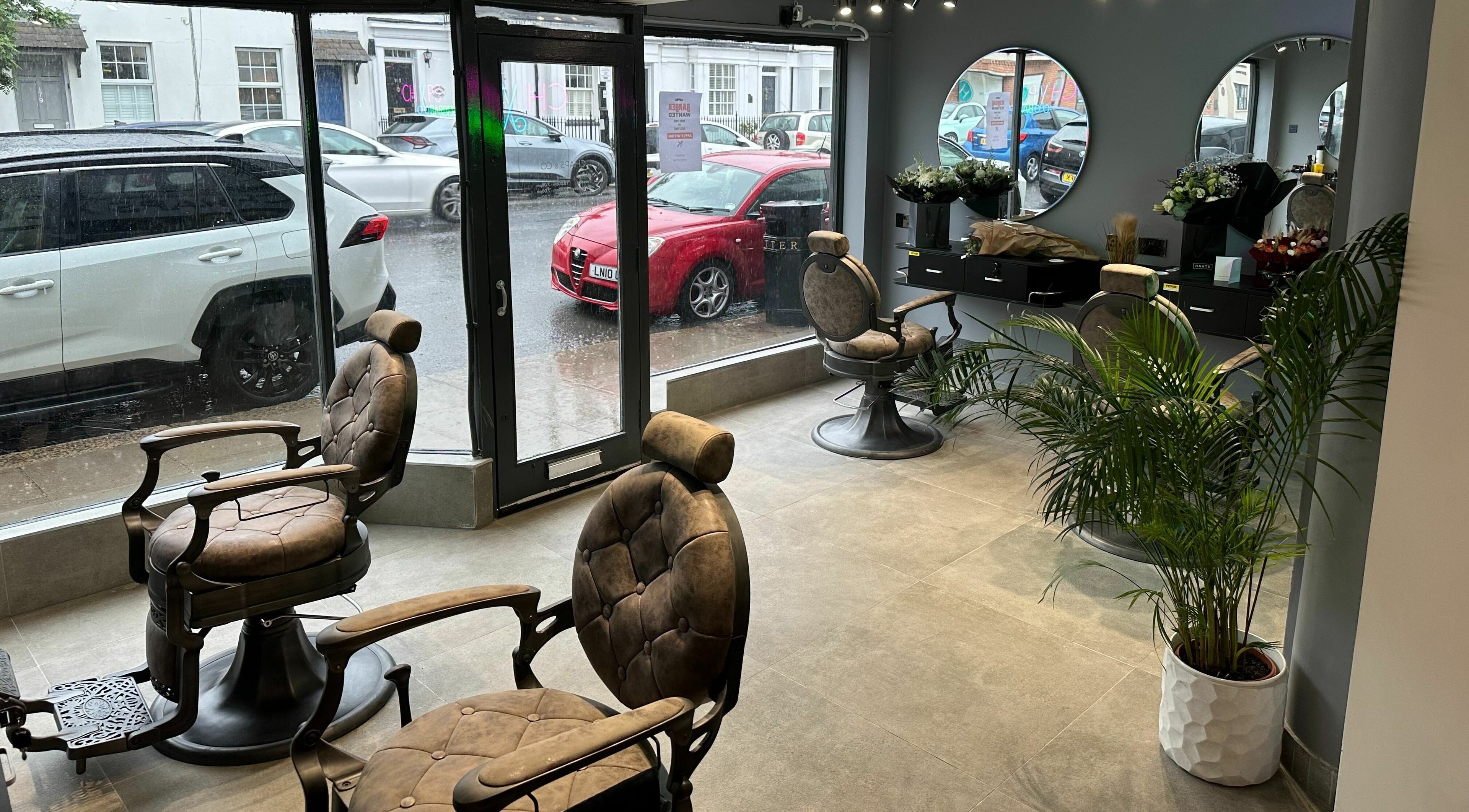 Modern barber chairs and decor at Chaps Cut, Barnet, England, GB, highlighting sleek style and comfort.