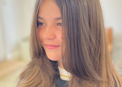 Young woman with shiny, sleek hair styled at The Hair Studio, Banbury, England, GB.