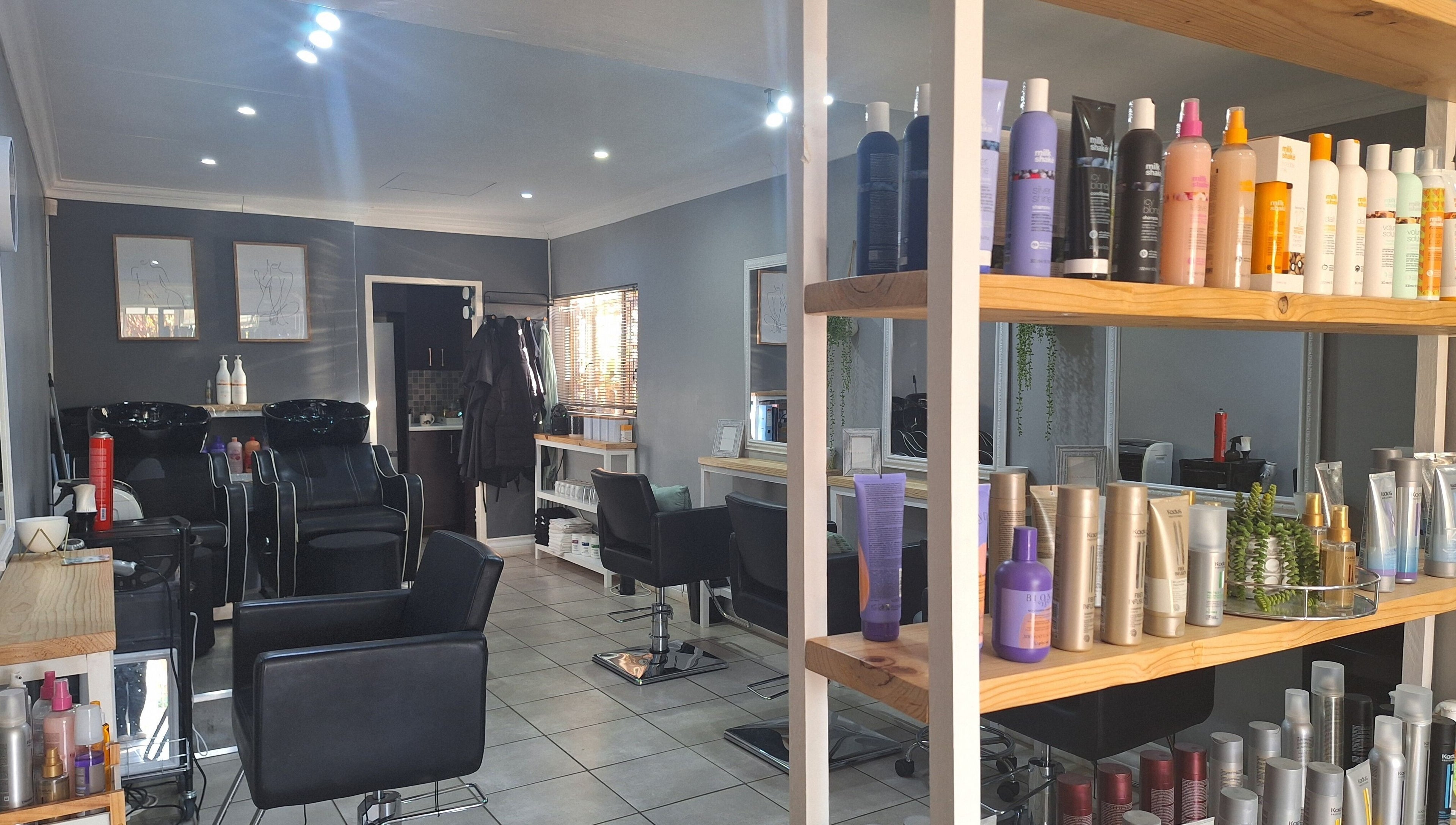 Interior of Refresh Skin Health Salon in Pretoria, Gauteng, ZA; showcasing sleek styling stations and a range of beauty products.