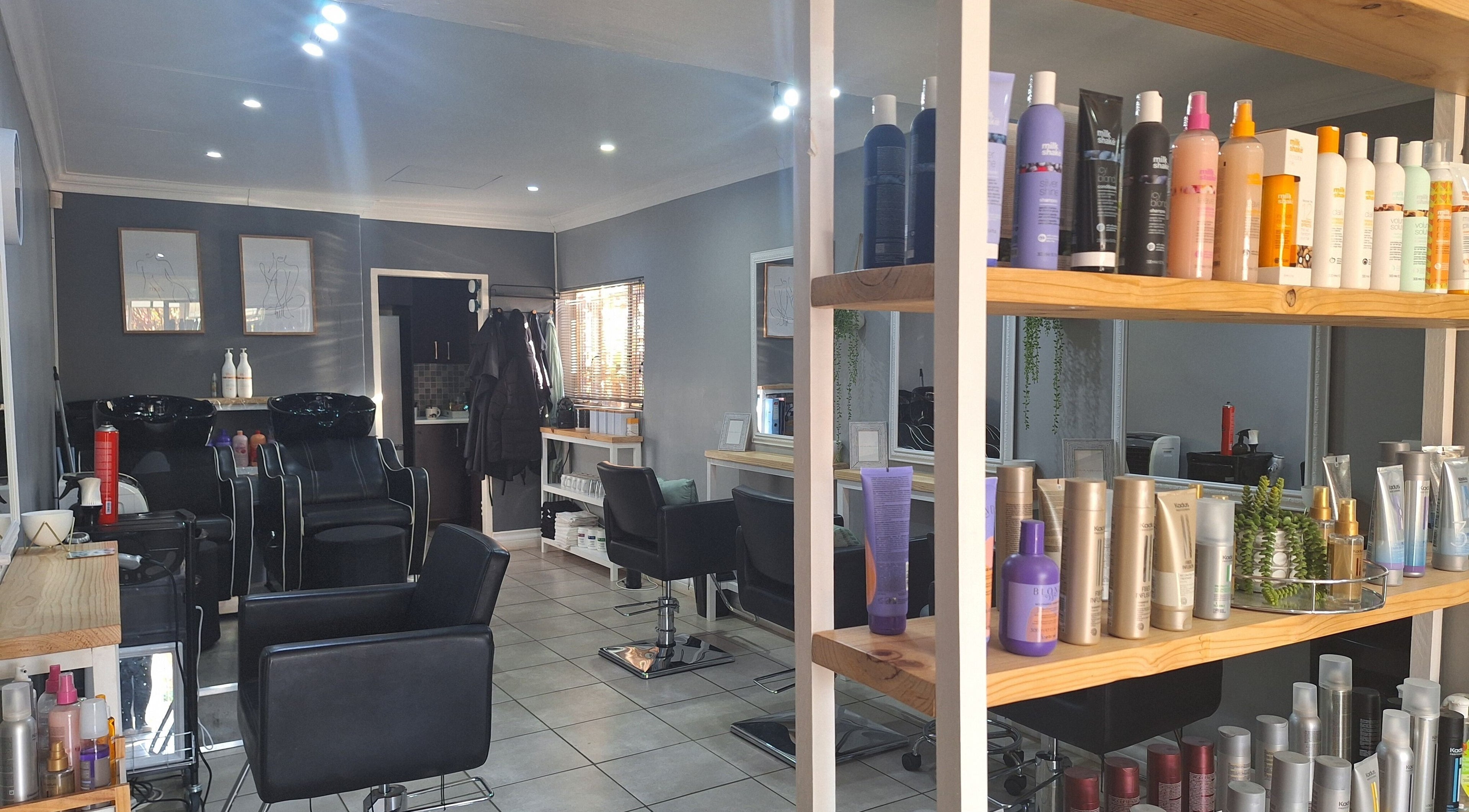 Interior of Refresh Skin Health Salon in Pretoria, Gauteng, ZA; showcasing sleek styling stations and a range of beauty products.