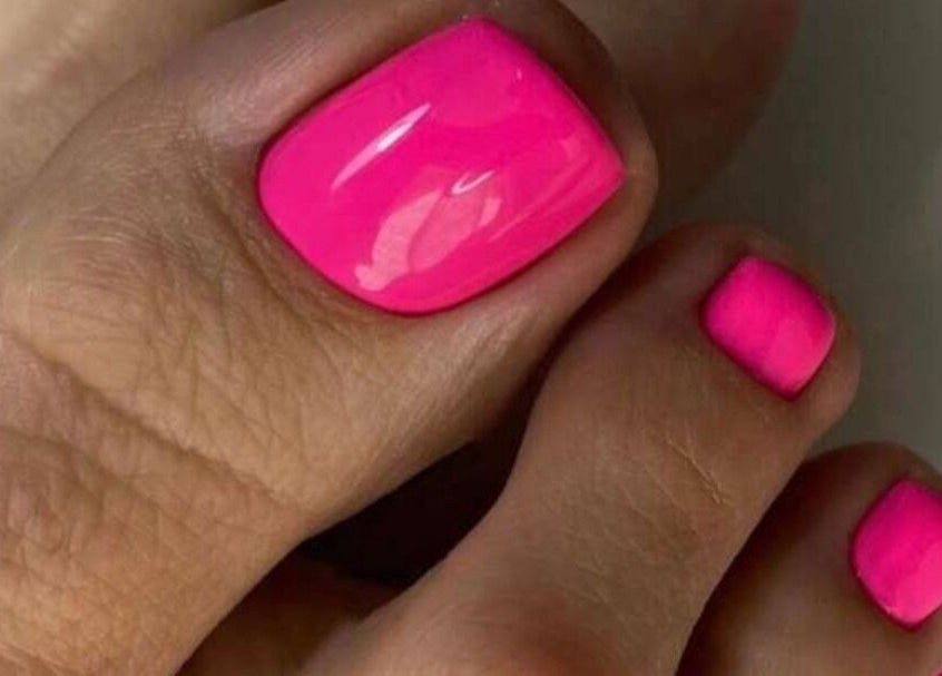 Bright pink pedicure at Refresh Skin Health Salon, Pretoria, Gauteng, ZA enhancing nail beauty.