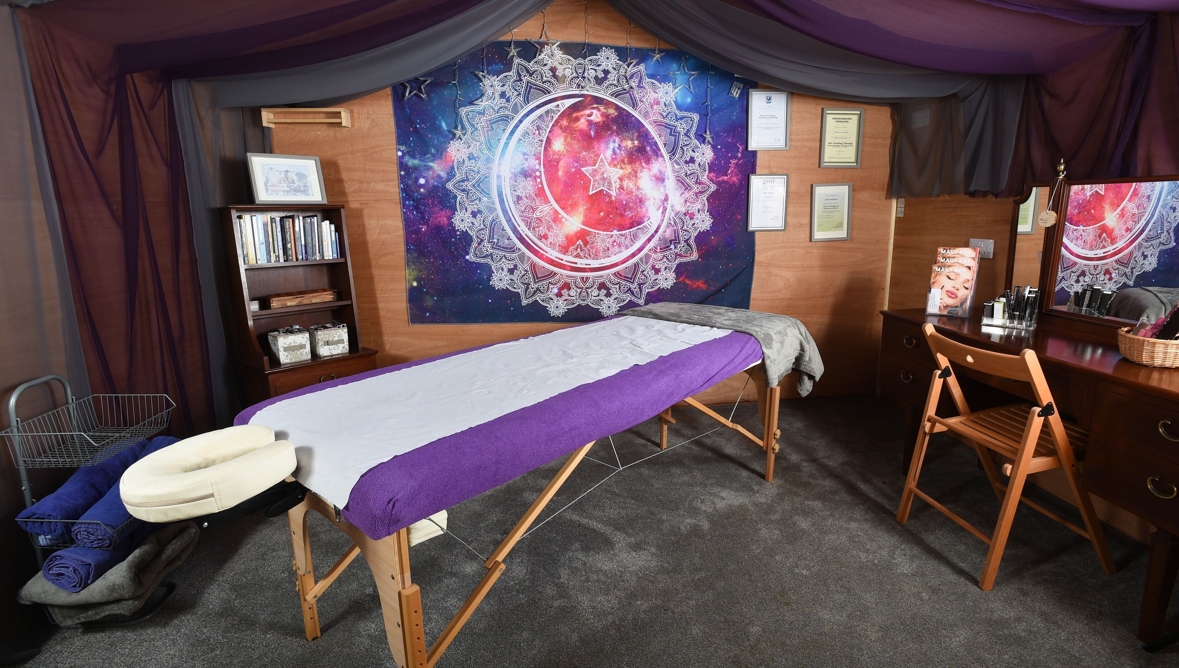 Relaxing therapy room at Trinity Wellness, Stokenchurch, England, GB with cosmic decor and massage table.
