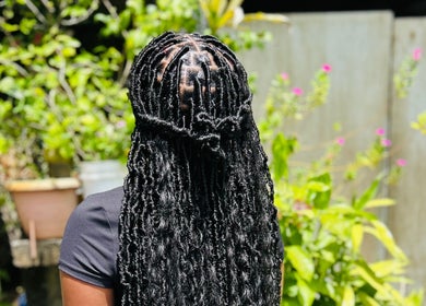 Exquisite braided hairstyle at Kalis Hair Lab in Saint John, Antigua and Barbuda, DM.