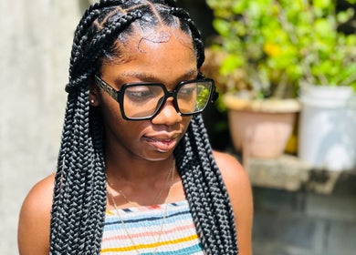 Woman with braided hairstyle at Kalis Hair Lab, Saint John, Antigua and Barbuda.