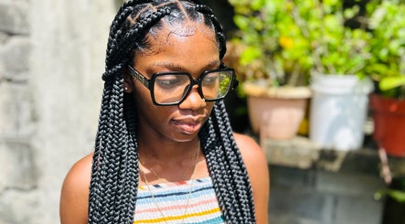 Woman with braided hairstyle at Kalis Hair Lab, Saint John, Antigua and Barbuda.