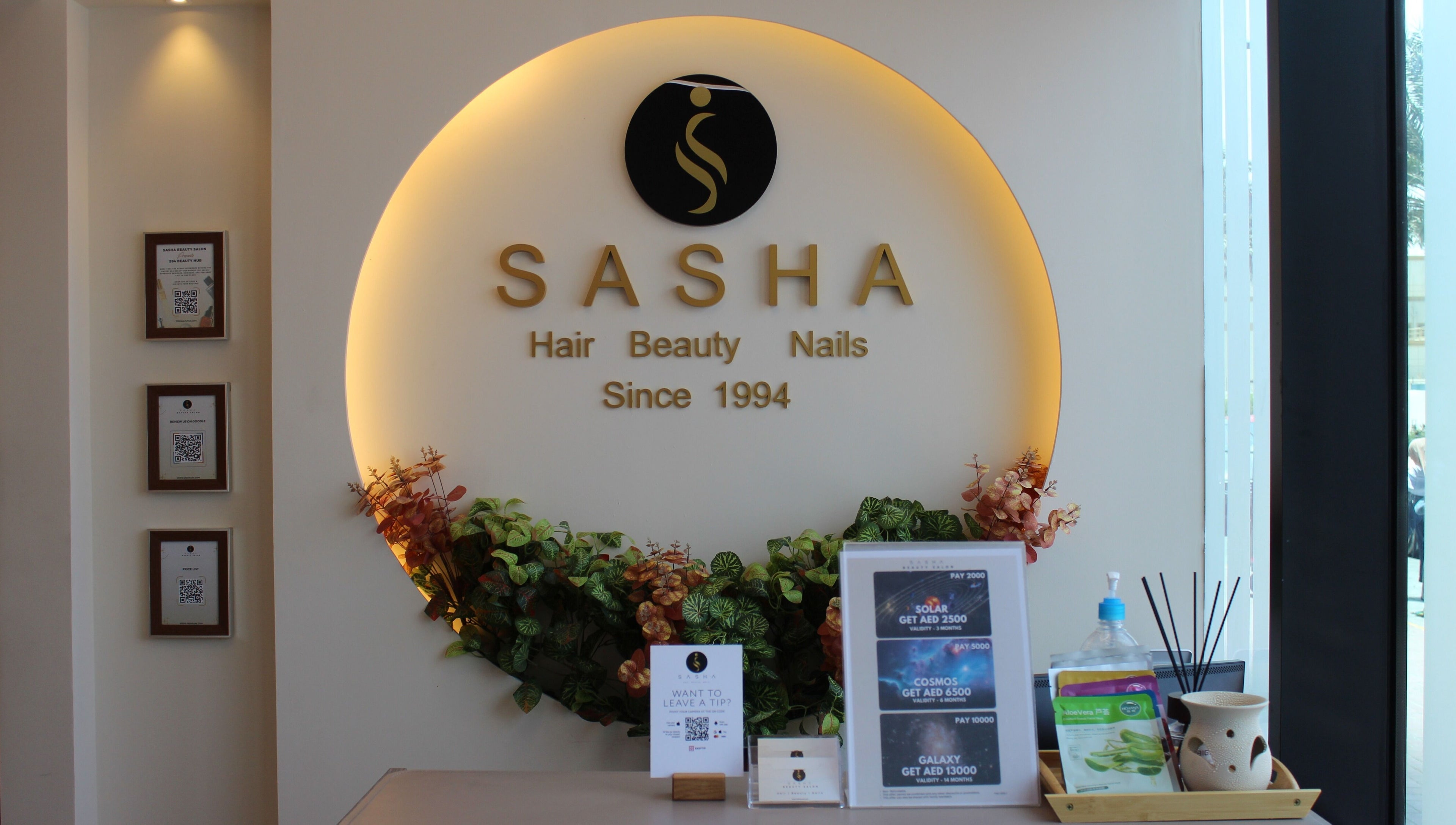 Warm, elegant interior of Sasha Beauty Salon JVC Branch JVC in Dubai, AE, showcasing floral decor and reception.