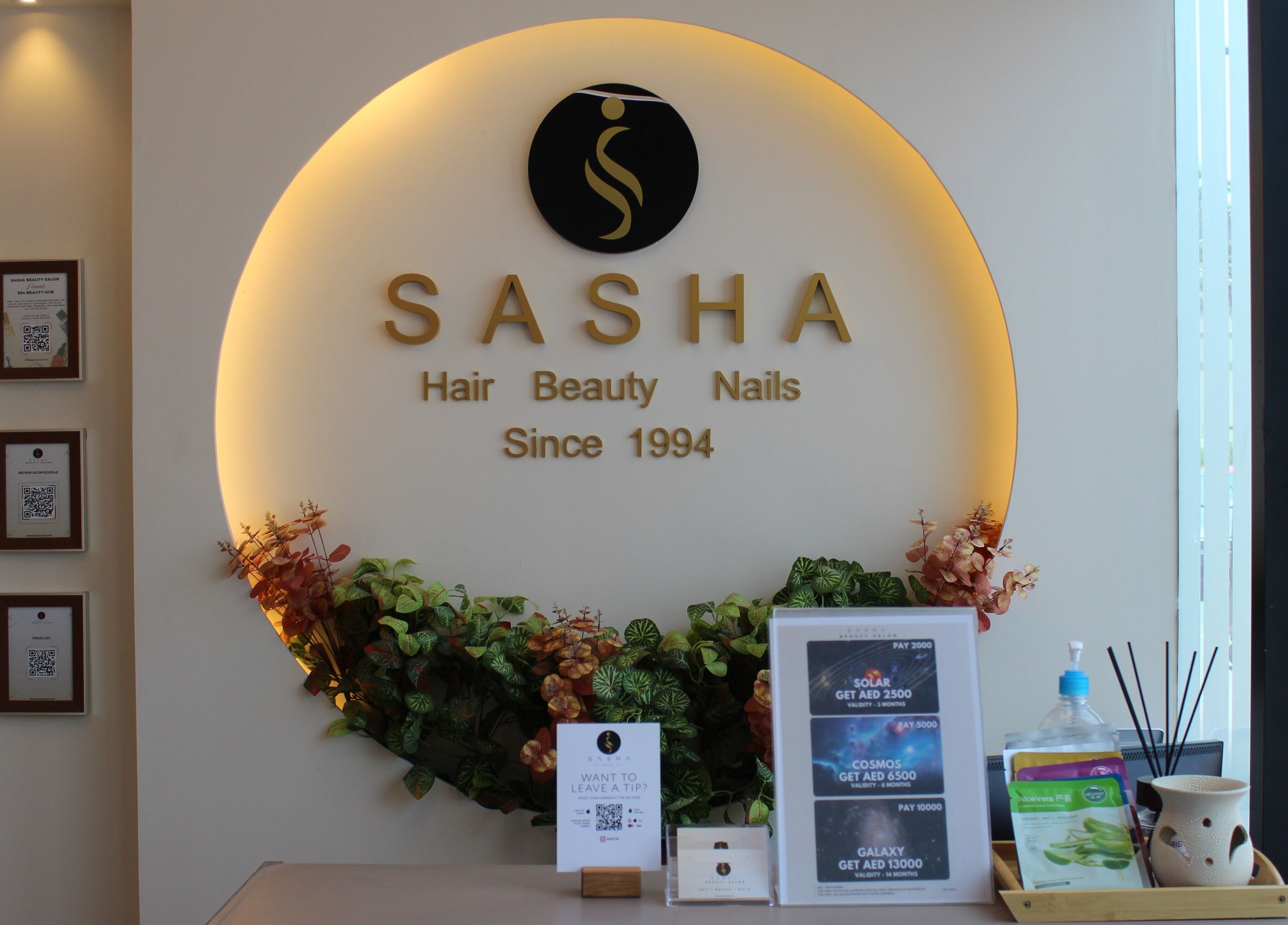 Warm, elegant interior of Sasha Beauty Salon JVC Branch JVC in Dubai, AE, showcasing floral decor and reception.
