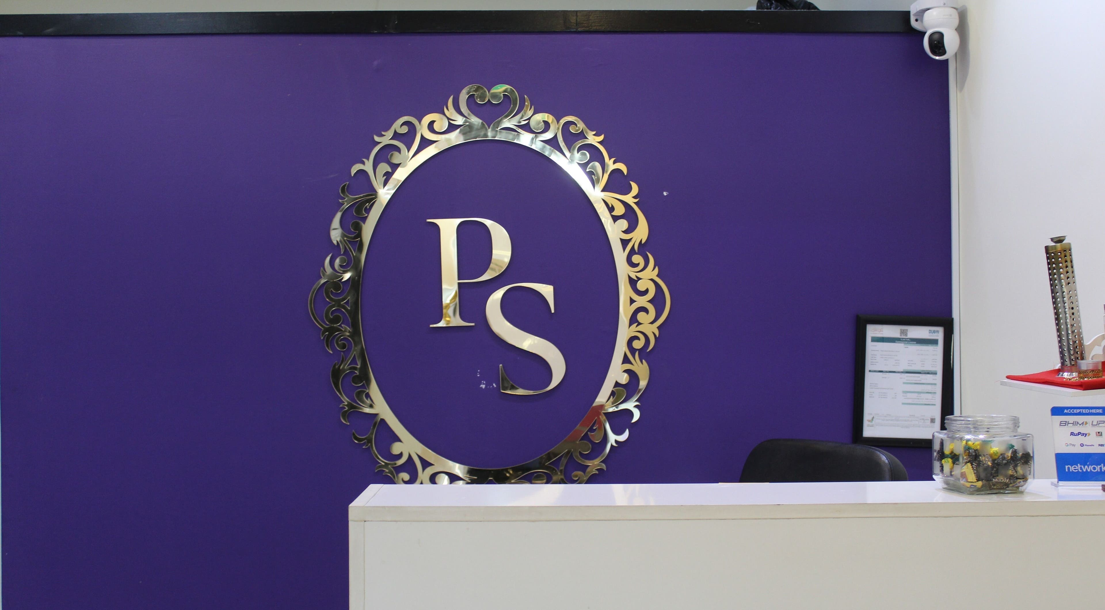 Reception area of Posh Signature Salon in Dubai, AE, featuring a purple wall with stylish logo.