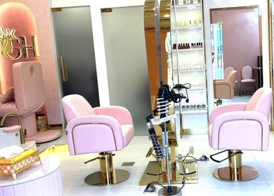 Elegant Glam Hub Beauty Centre chairs in pink and gold, Dubai, AE, offering premium salon services.
