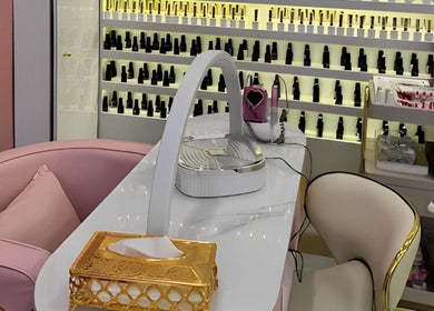 Manicure station at Glam Hub Beauty Centre, Dubai, AE, showcasing elegant decor and nail polish selections.