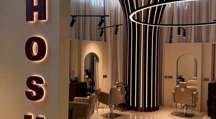 Modern interior of HOSH - House Of Shroug Salon in Riyadh, SA featuring stylish chairs and lighting.
