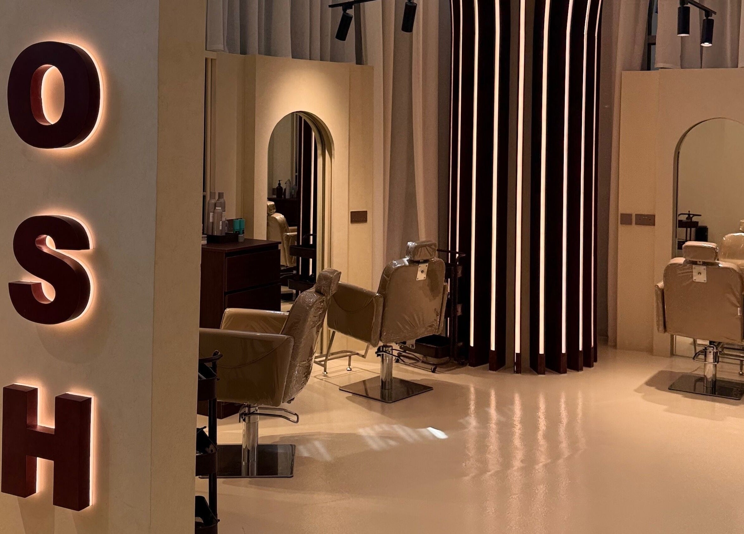 Interior of HOSH - House Of Shroug Salon in Riyadh, SA, featuring stylish salon chairs and mirrors.