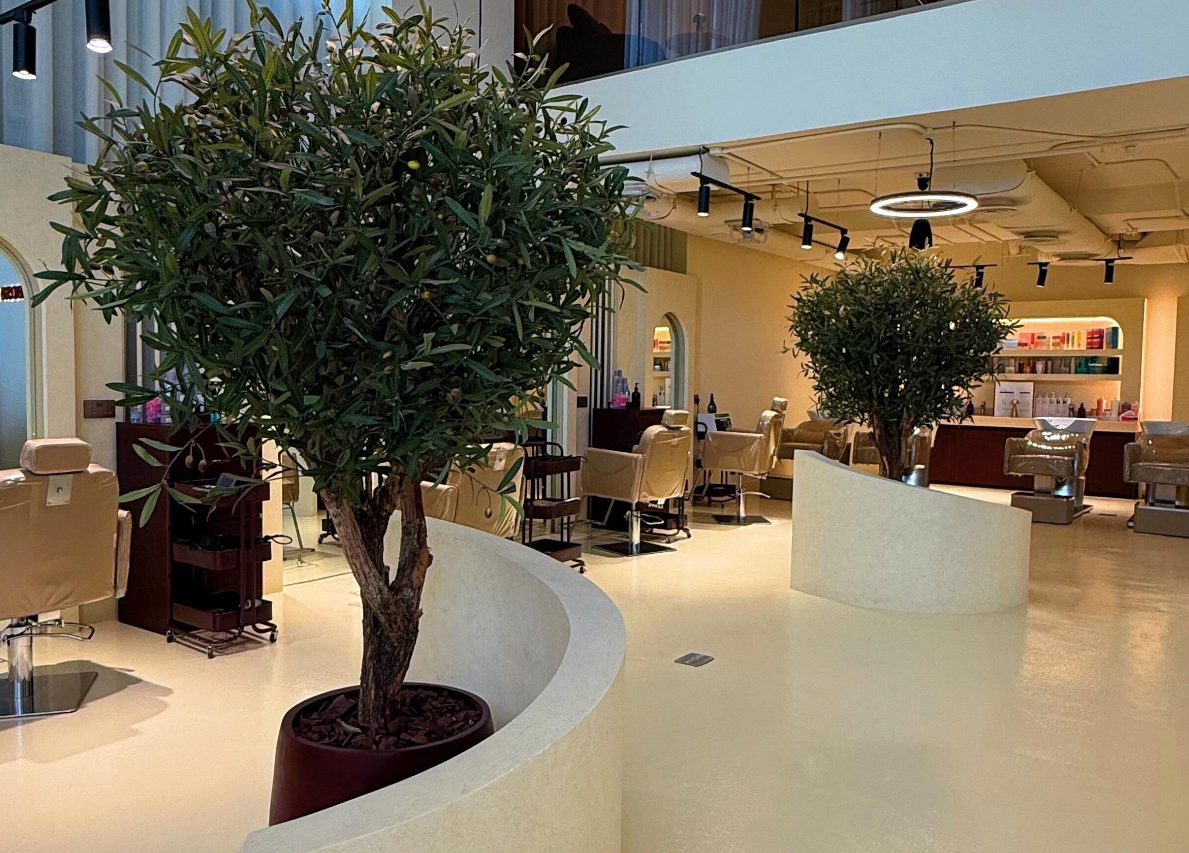 Stylish interior of HOSH - House Of Shroug Salon in Riyadh, SA with elegant seating and lush greenery.