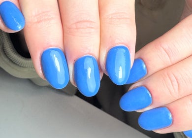 Bright blue manicured nails at Get Frenched, Chesterfield, England, GB.