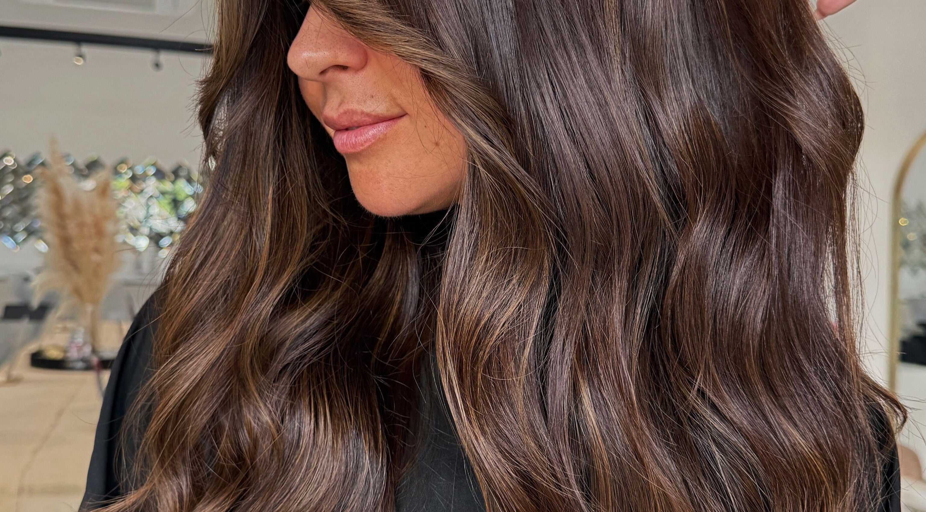 Lush, wavy brunette hairstyle at Chloe Ward Hair, Derby, England, GB, showcasing natural elegance.