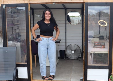 Woman smiling at LP Extensions, Fordingbridge, England, GB, stylish salon studio entrance with decor.