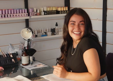 Smiling stylist at LP Extensions nail station, Fordingbridge, England, GB.