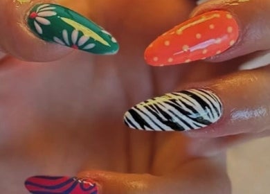 Colorful nail art at LP Extensions, Fordingbridge, England, GB showcasing floral and zebra patterns.
