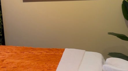 Relaxing massage bed with orange blanket at HoliSoi / HoliSelf, Montréal, Québec, CA.