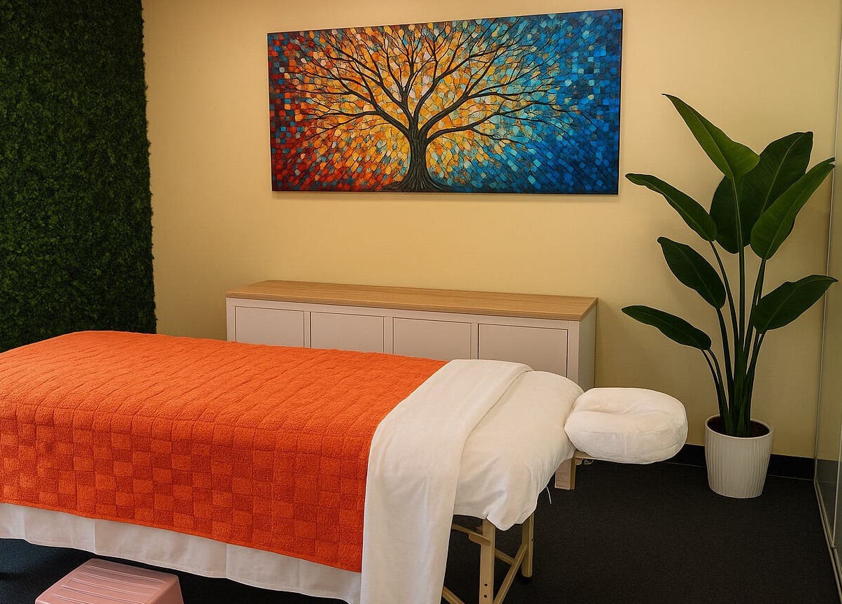 Serene massage room at HoliSoi / HoliSelf, Montréal, Québec, CA, featuring art and a vibrant plant.