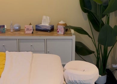 Relaxing massage table setup at HoliSoi / HoliSelf in Montréal, Québec, CA, with calming decor and vibrant plant.