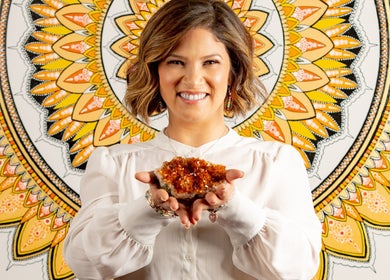 Smiling person holding crystal in front of mandala at HoliSoi/HoliSelf, Montréal, Québec, CA.