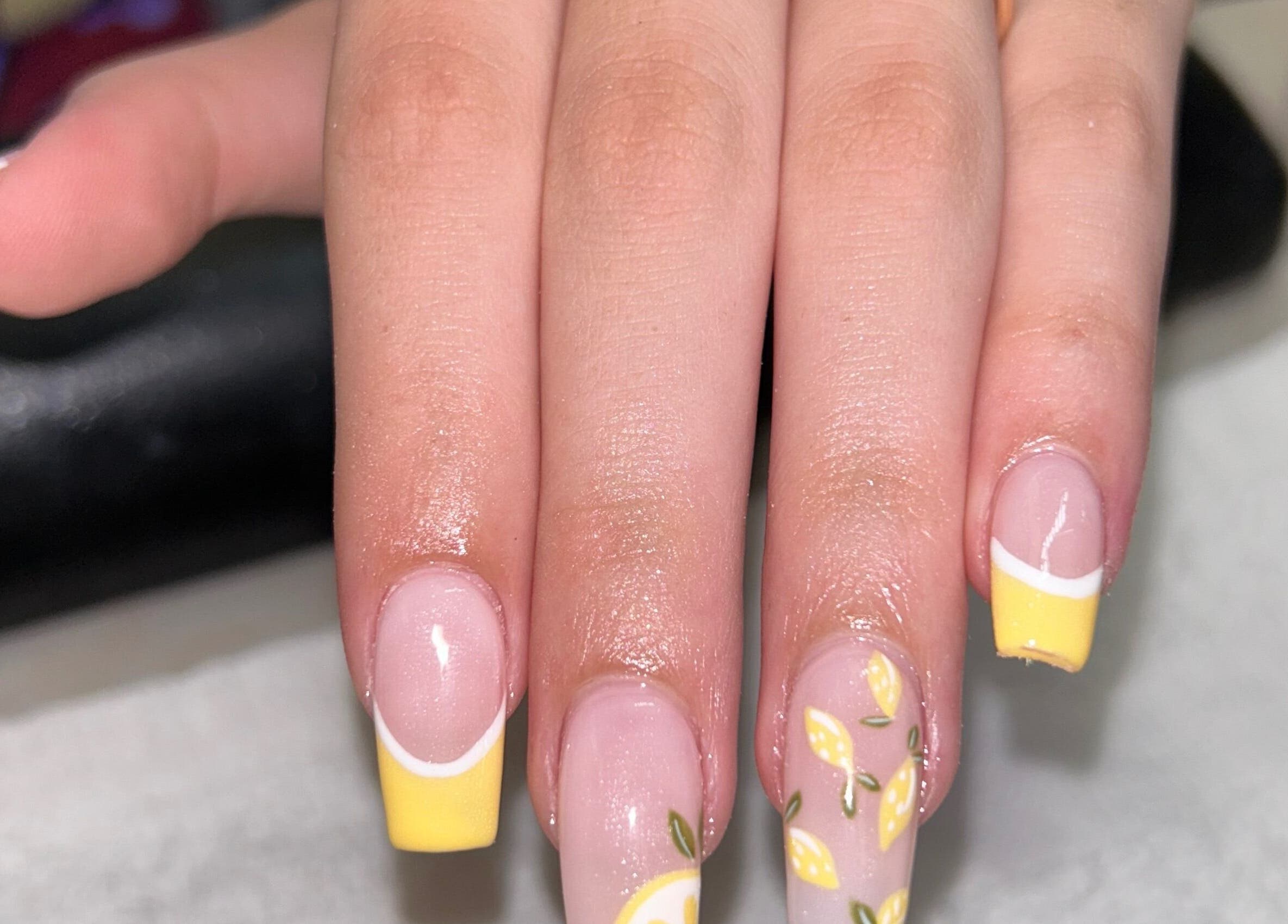 Lemon-themed nail art at The Lacquer Bar, Chatham, Ontario, CA showcasing vibrant yellow tips.