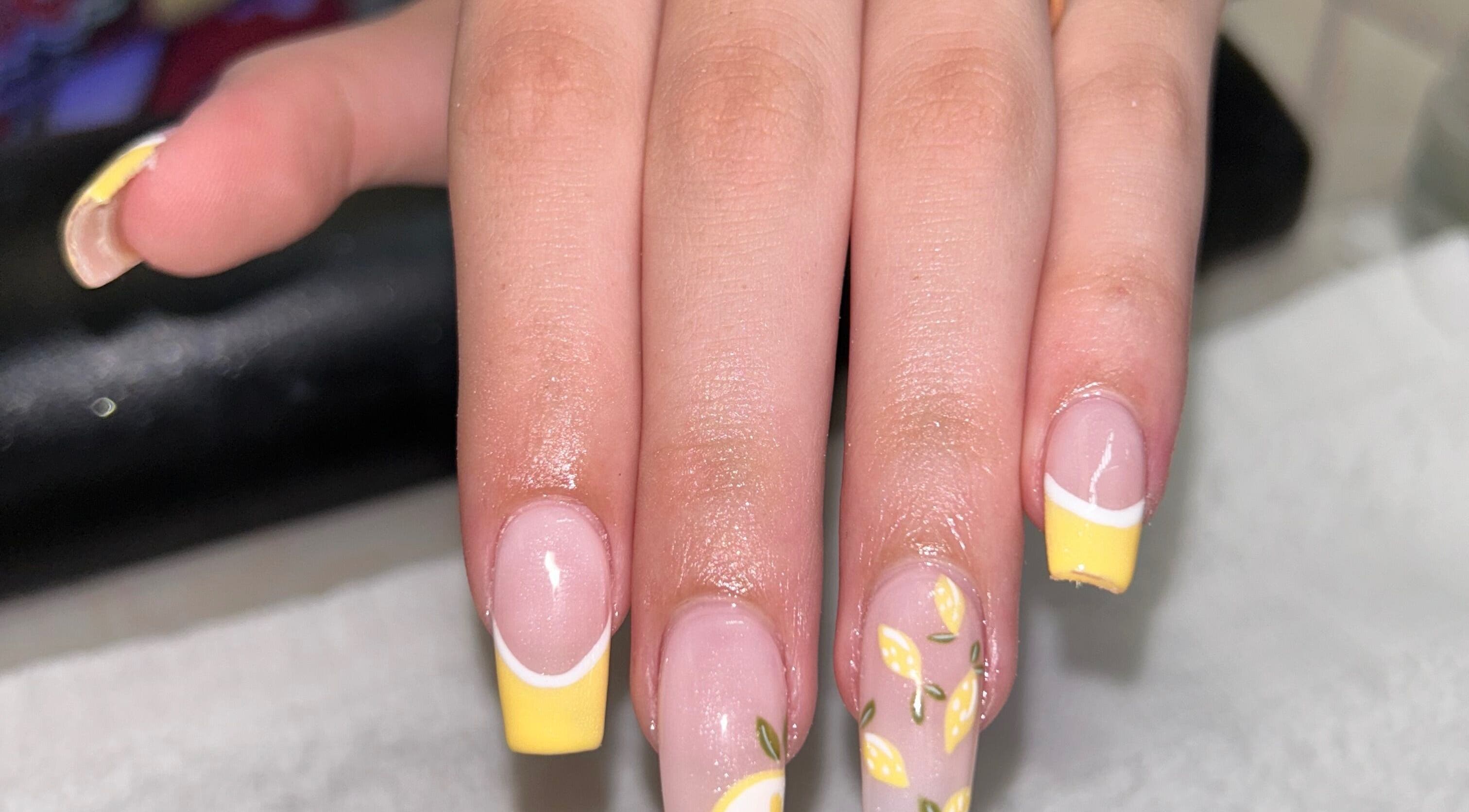 Lemon-themed nail art at The Lacquer Bar, Chatham, Ontario, CA showcasing vibrant yellow tips.
