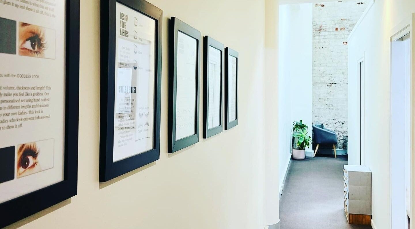 Framed lash art on the hallway wall of Holylashes North Melbourne, a beauty venue in Melbourne, Victoria, AU.