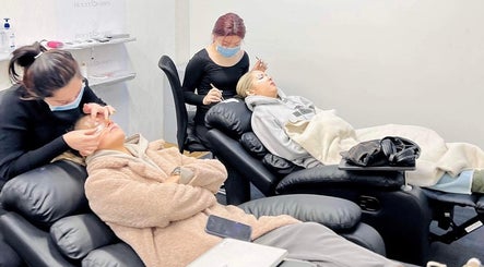 Clients receiving eyelash extensions at Holylashes North Melbourne, Melbourne, Victoria, AU in relaxing chairs.