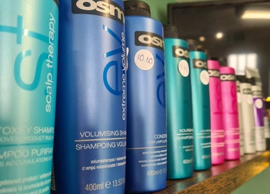 Diverse shampoo bottles on a shelf at The Green Lounge in Haughley, England, GB.