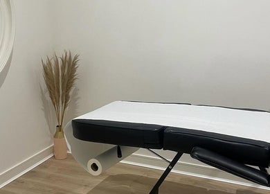 Calming treatment room at Body Secrets - West London, London, England, GB with massage table and decor.