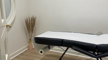 Calming treatment room at Body Secrets - West London, London, England, GB with massage table and decor.