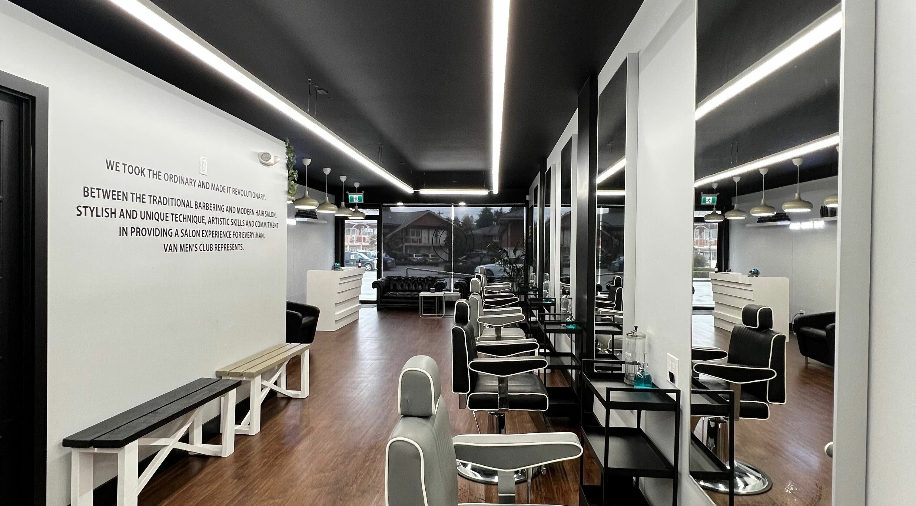 Stylish interior of Van Men's Club Barbershop in Vancouver, BC, CA with modern black and white decor.