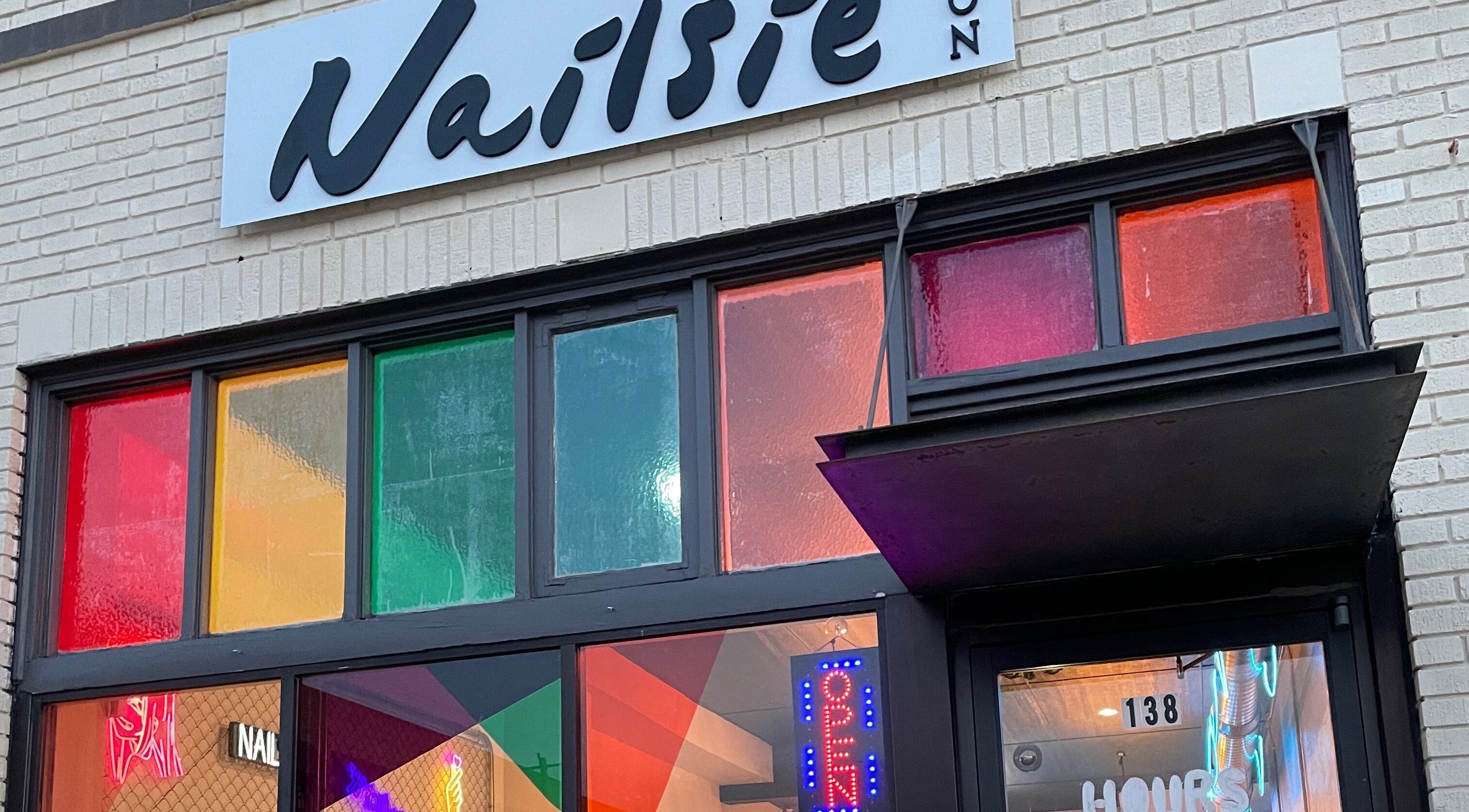 Front view of Nailsie in Oklahoma City, Oklahoma, US with colorful windows and open sign.