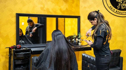 Stylist perfecting long hair at Exotic Indian Salon Richmond, New South Wales, AU.
