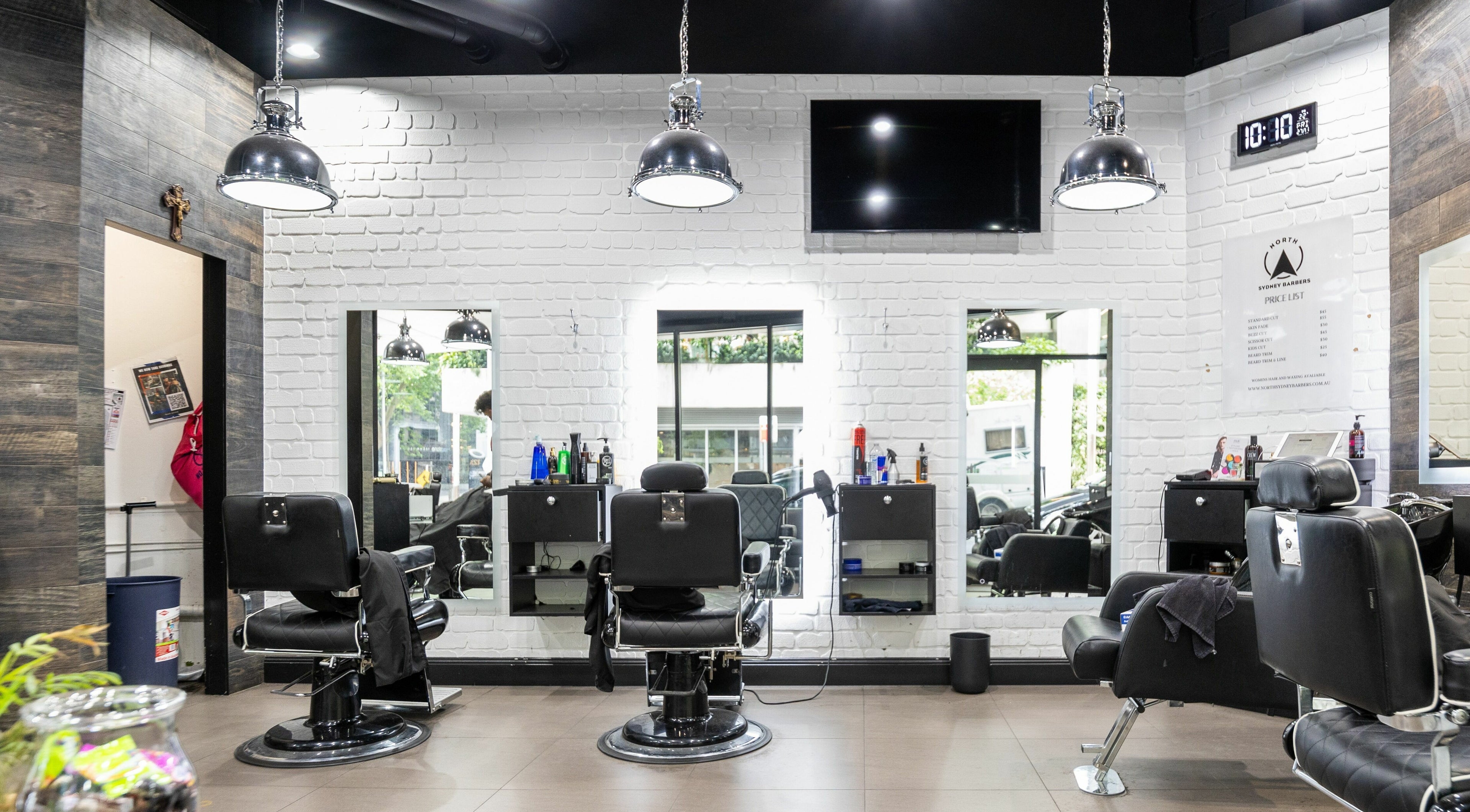Interior of North Sydney Barbers showcasing sleek chairs and mirrors, North Sydney, New South Wales, AU.