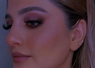 Close-up of a woman with elegant makeup and earrings at La Femme Salon & Nail Spa, Al Khobar, Eastern Province, SA.
