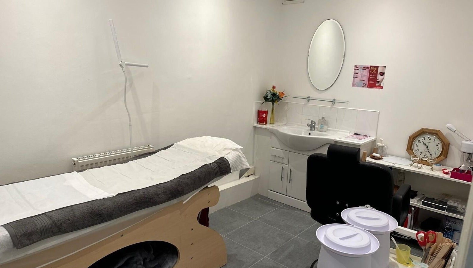 Sleek treatment room at Totally Tips and Toes in London, England, GB, featuring a bed and modern amenities.