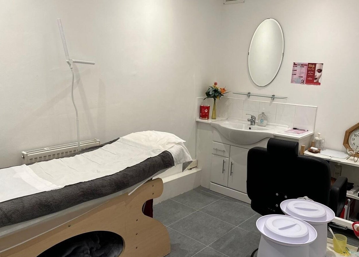 Sleek treatment room at Totally Tips and Toes in London, England, GB, featuring a bed and modern amenities.