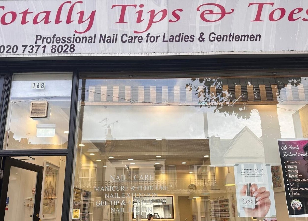 Front view of Totally Tips and Toes nail salon in London, England, GB, showcasing stylish signage and inviting entrance.