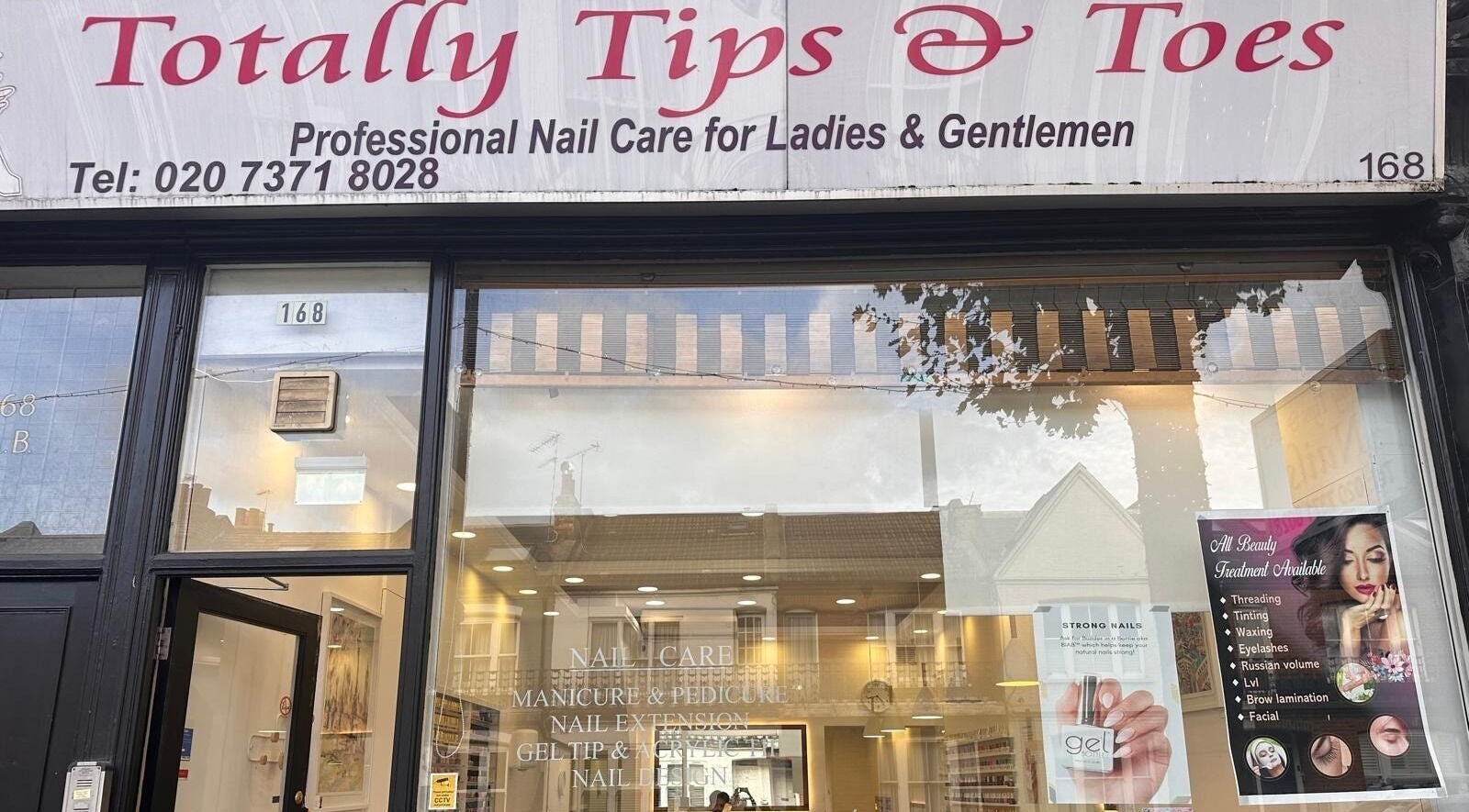 Front view of Totally Tips and Toes nail salon in London, England, GB, showcasing stylish signage and inviting entrance.